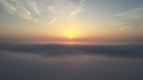 Aerial-shot-of-atmospheric-sunrise-above-the-clouds