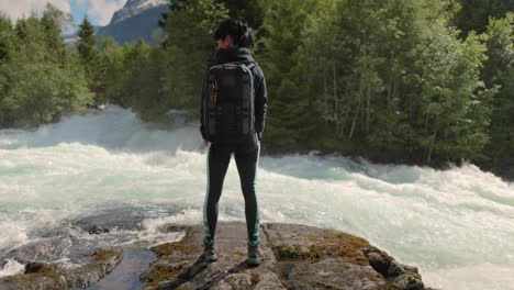 hiking woman walk with a hiking backpack in beautiful nature of norway.