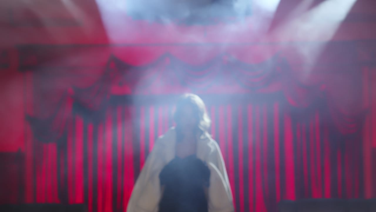 a mysterious and beautiful woman in an evening dress and high heels climbs the stairs into the smoky room