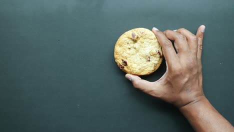 Top-view-of-hand-pick-a-cookies-from-a-table-,