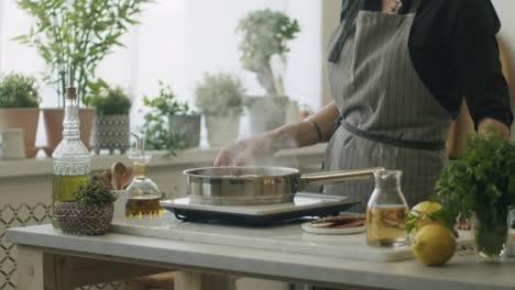 woman cooking ossobuco and closing pan with lid