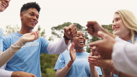 group of diverse volunteers clapping and smiling together