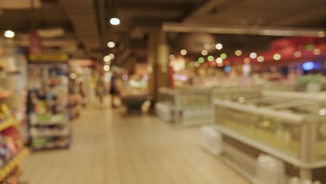 people with shopping carts. people are shopping in a supermarket, defocused blurred background.