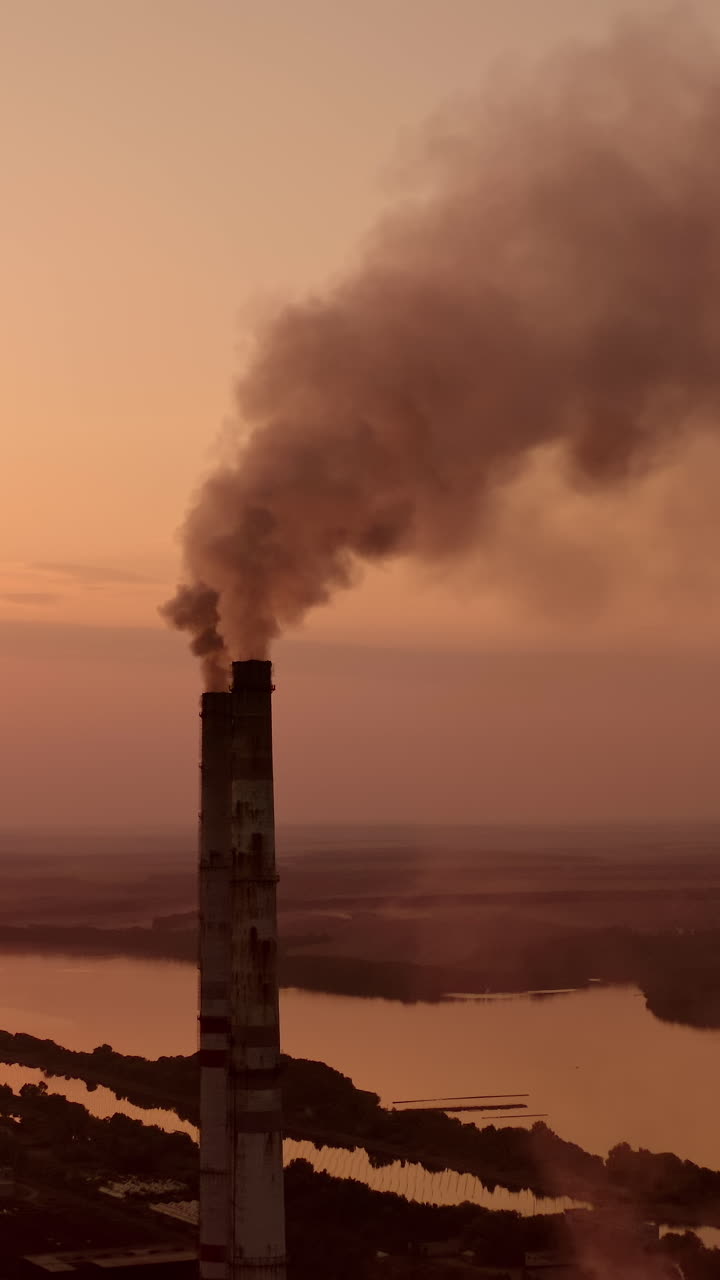 Power pylons on sunset time background. High voltage electric tower at the sunset. Fabric concept. Selective focus. Vertical video