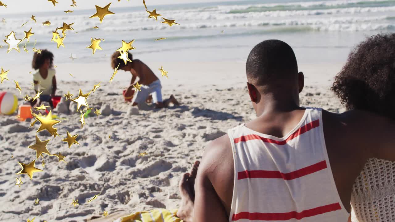Family building sandcastle at shoreline sparking confetti drifting for travel promotion