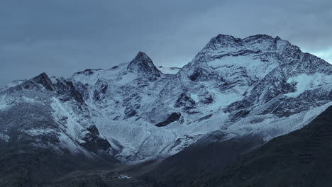 Saas-Fee-Saastal-Zermatt-Switzerland-aerial-drone-snow-dusting-grey-cold-dark-gondola-Metro-Alpin-tram-Swiss-Alpine-Alps-chalet-valley-mountains-glacier-Feevispa-circle-right