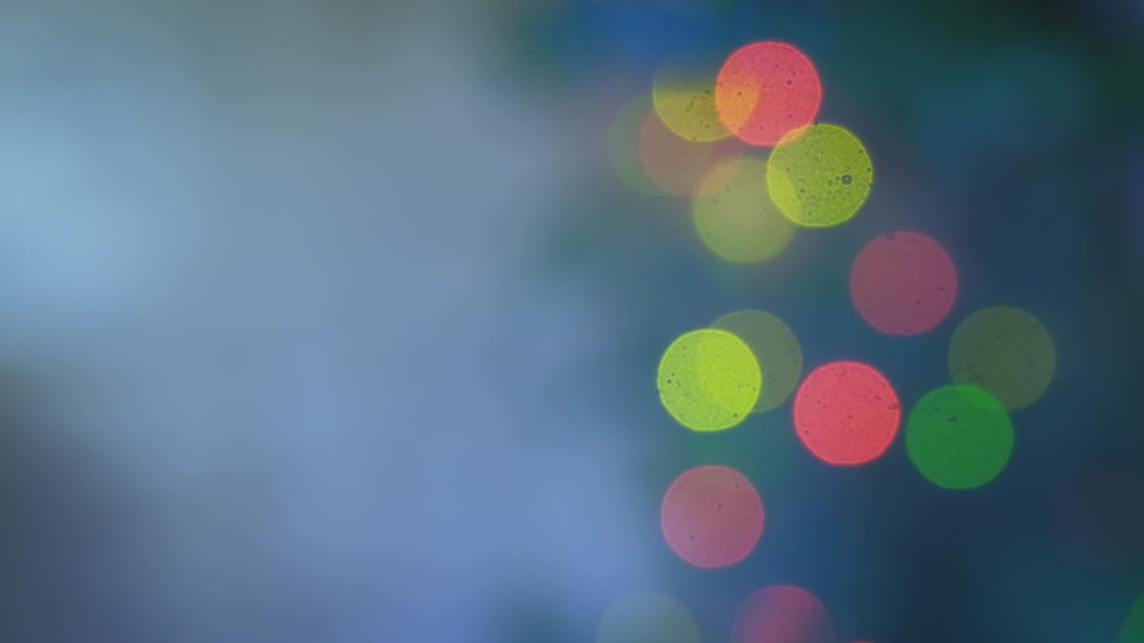 Red green and yellow blurred light spots. Background of defocused christmas lights