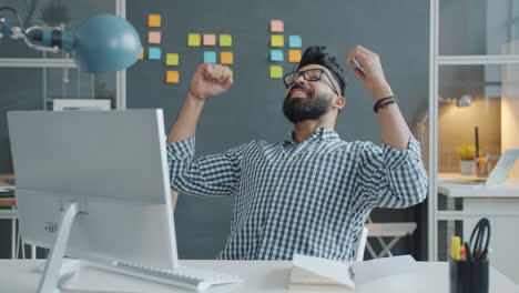 Happy Business Man Celebrating Success at His Desk
