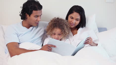 family looking a child book
