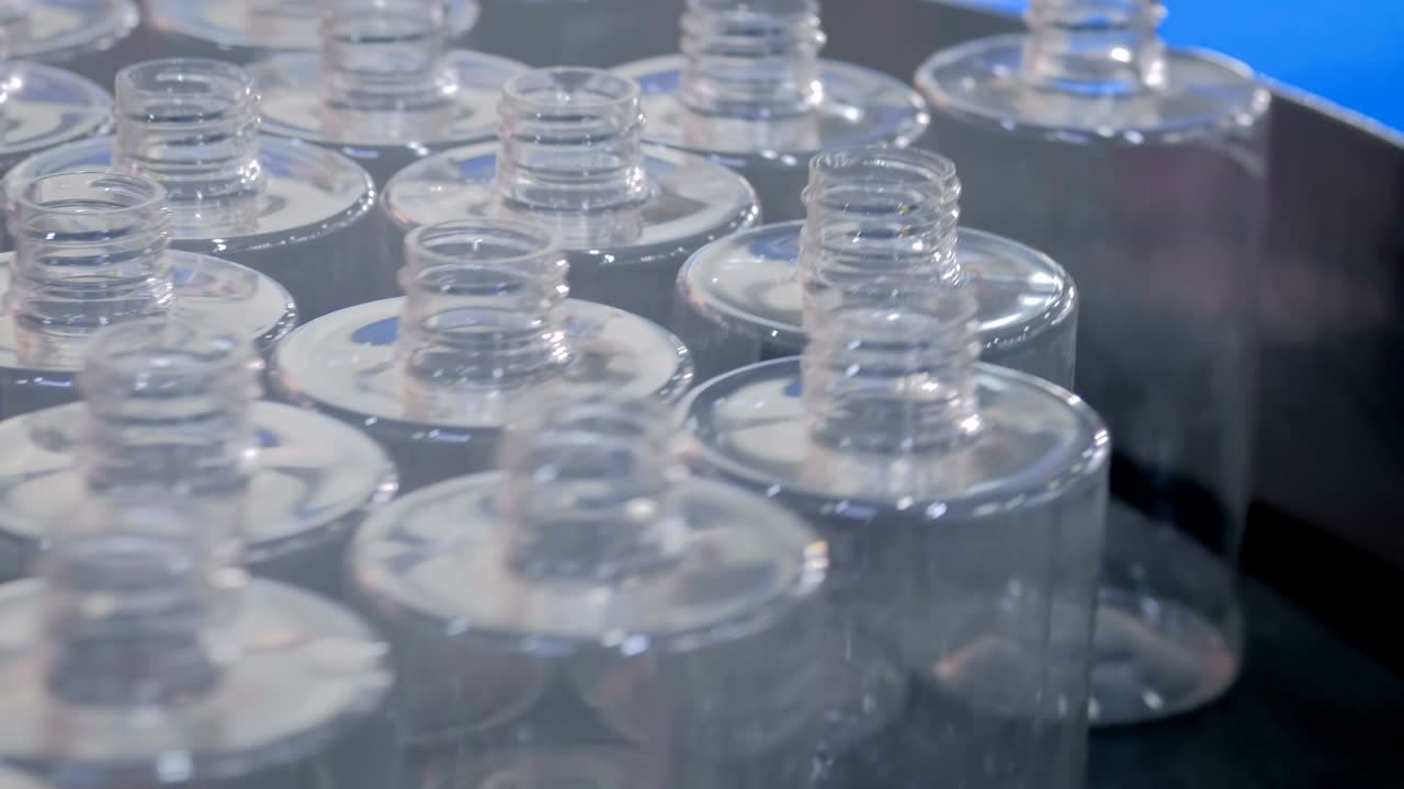 Automated pharma technology concept - rotating platform with empty glass bottles