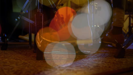 drum hardware being animated, showing hi-hat stand and pedal pressing on patterned rug with bokeh