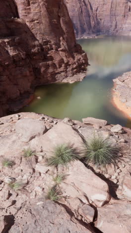 a scenic view of a canyon with a lake in the background