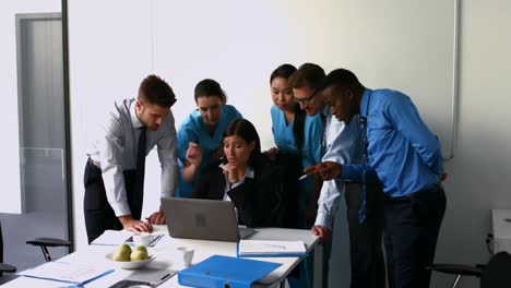 Team-of-doctors-discussing-over-laptop