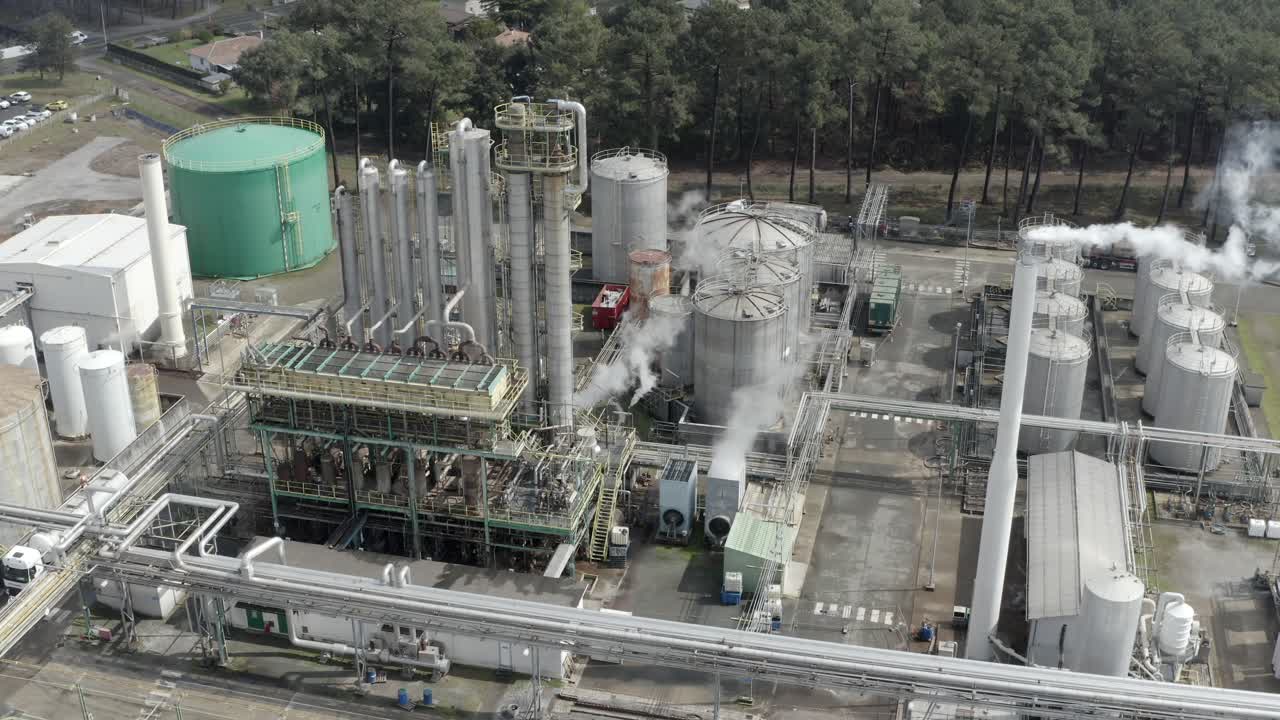 Aerial drone view of industrial factory exterior, showing complex network of pipes, tanks, and structures, Veille-Saint-Girons, France