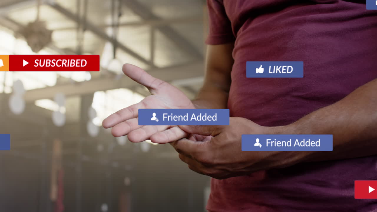 Animation of social media notifications over african american man inspecting hand at gym