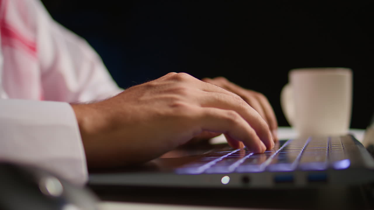 Man typing on laptop, extreme close up
