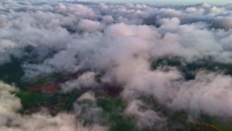 green countryside of latvia from above clouds, aerial view