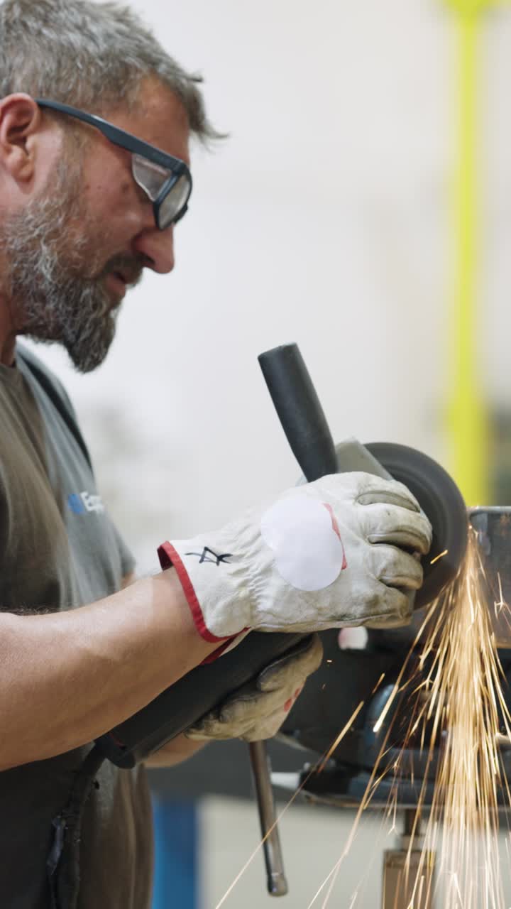 Man using angle grinder in workshop