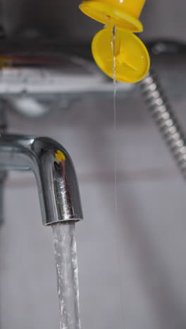 pouring water from tap and gel in bathtub in washroom. filling basin with warm liquid and body cleansing cosmetic product at home. cozy bathroom