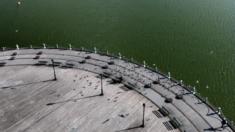 an aerial view of the semicircle boardwalk on meadow lake in queens, new york on a sunny day