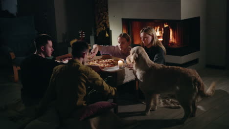 friends enjoying pizza by the fireplace