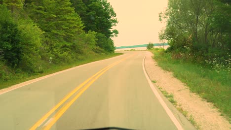 Warm-day-time-drive-by-of-peninsula-drive-in-traverse-city,-MI