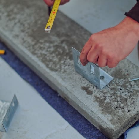 builders work with instruments. hands of a worker measuring metal thing. construction for solar panels. close-up.