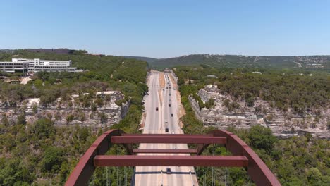 fly over reveal drone shot of the pennybacker bridge in austin, texas