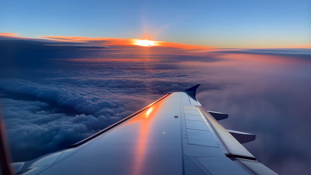 Stunning Sunrise/Sunset View from an Airplane Window Above the Clouds