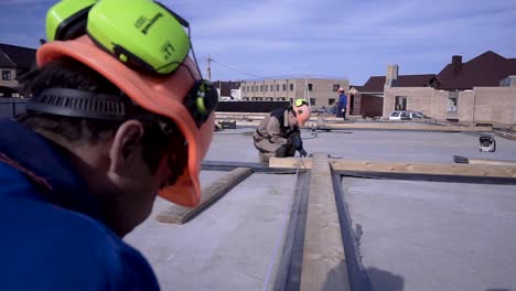 construction workers installing roof framing