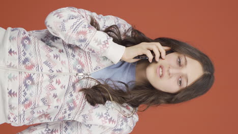 Vertical-video-of-Angry-young-woman-talking-on-the-phone.