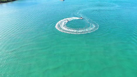 a boat creates circular patterns on water