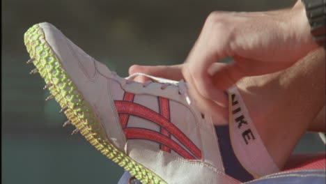 a man ties his shoelace