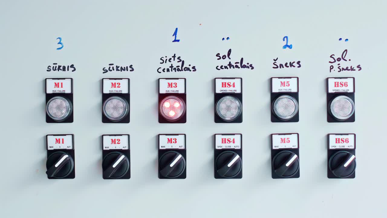 Row of power switches mounted on clean white panel under bright even lighting in close detail