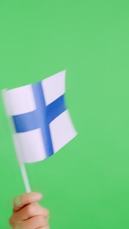 hand waving a pennant of a finnish national flag