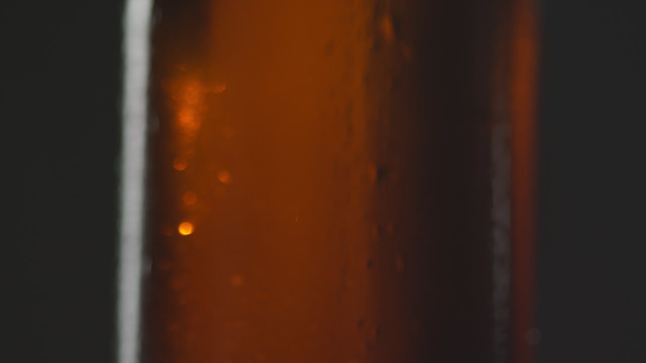 Pull Focus Shot Of Close Up Of Condensation Droplets On Bottle Of Cold Beer Or Soft Drink
