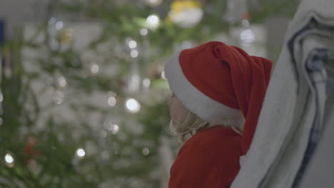 disappointed toddler girl at christmas with grumpy expression looking at camera