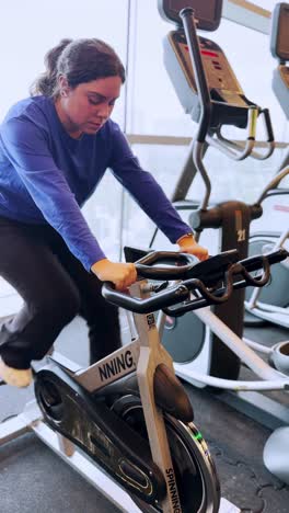 young woman doing spinning exercise at the gym