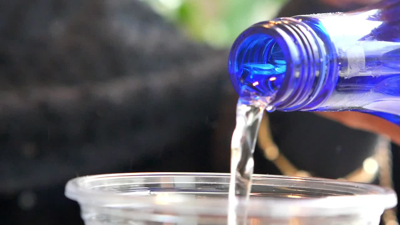 Water pouring into a cup