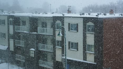 exterior slow motion of snowfall outside empty city apartment building