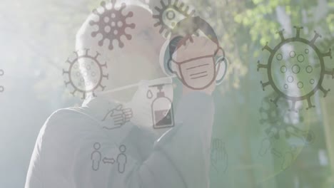 animation of covid 19 icons over senior man wearing face mask