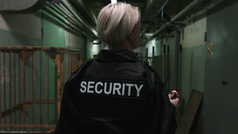 female safety guard with flashlight in a warehouse