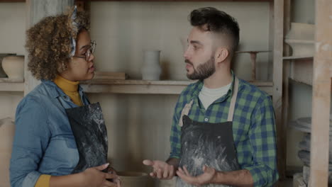 potters in a workshop discussing a design