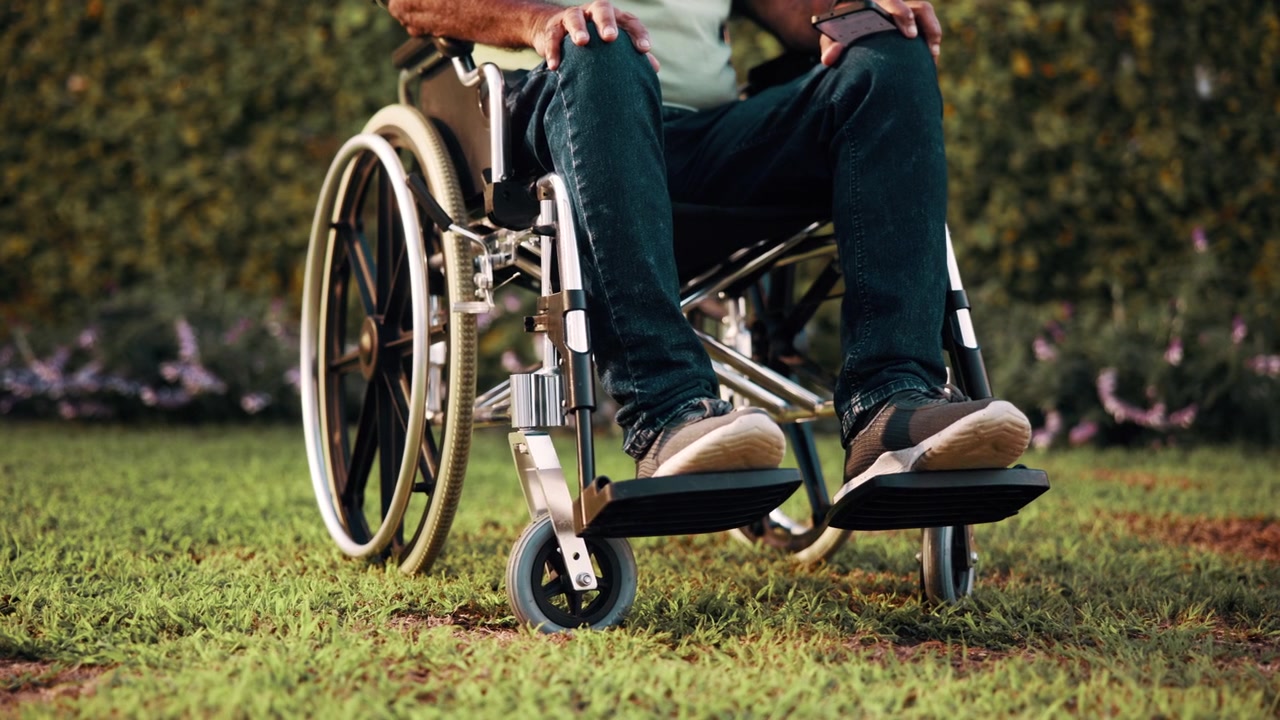 Person Sitting in a Wheelchair Outdoors on a Sunny Day