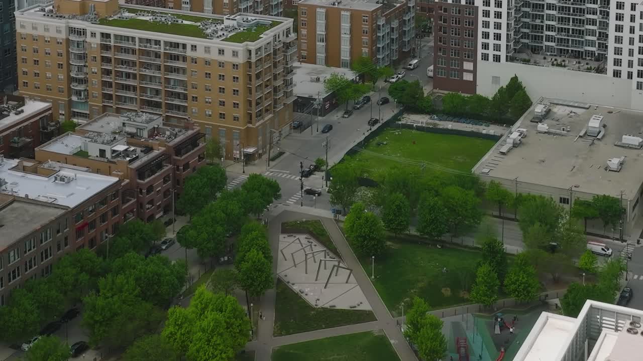 View of Chicago buildings and rooftops with greenery and a pool