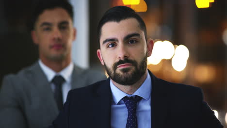 two-young-businessmen-standing-in-an-office