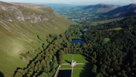 aerial views of a majestic stone castle nestled in a sprawling valley landscape