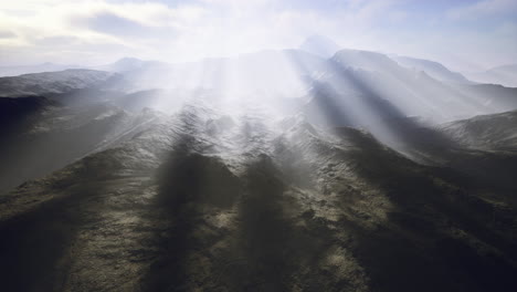 misty mountain landscape bathed in sunlight during early morning hours