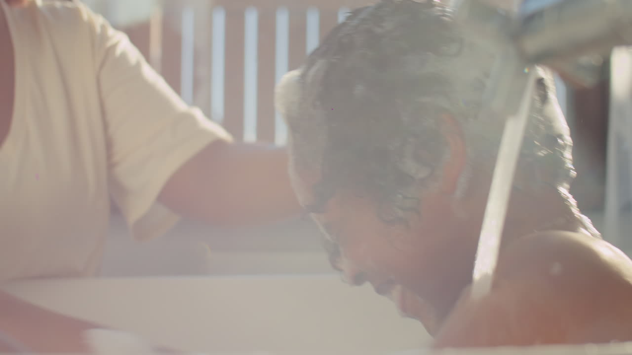 Kid and His Mother Playing with Water and Foam during Bathtime