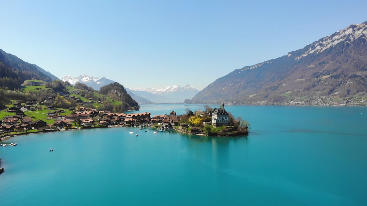 Stunning Aerial View of a Lake Village with a Castle in the Swiss Alps